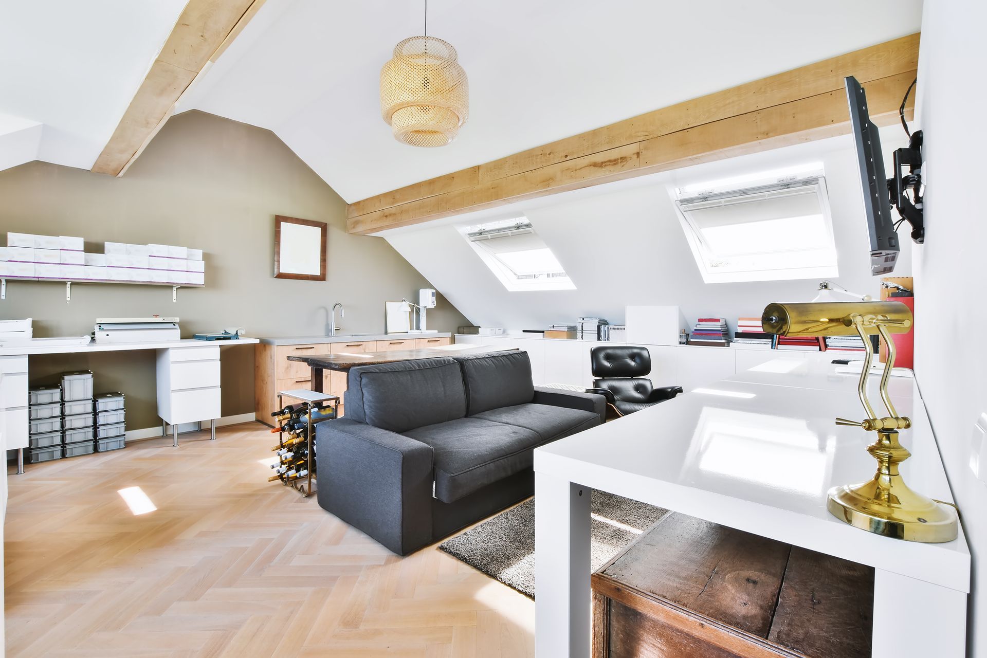 A living room with a couch , desk , and television.