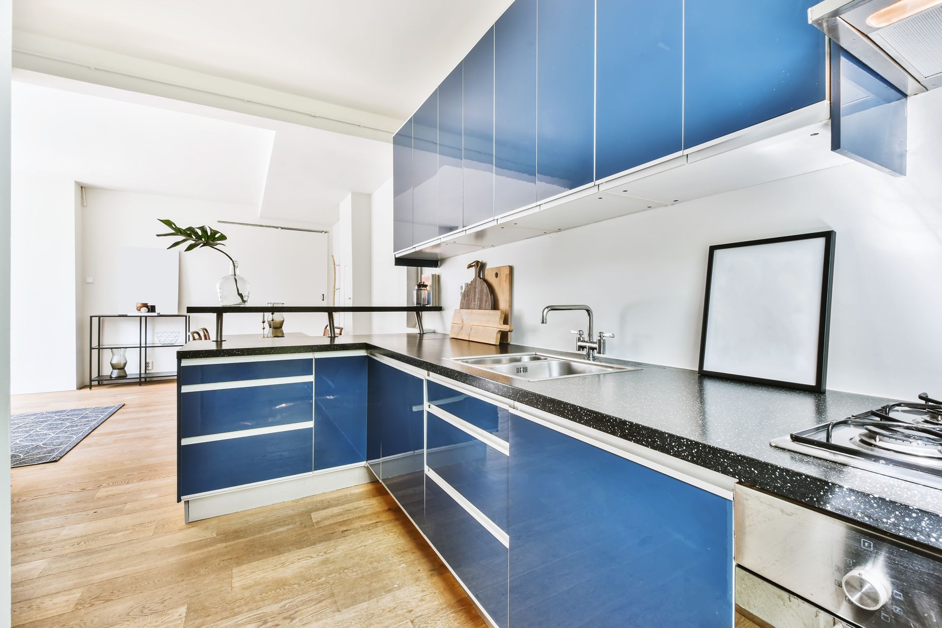A kitchen with blue cabinets and stainless steel appliances