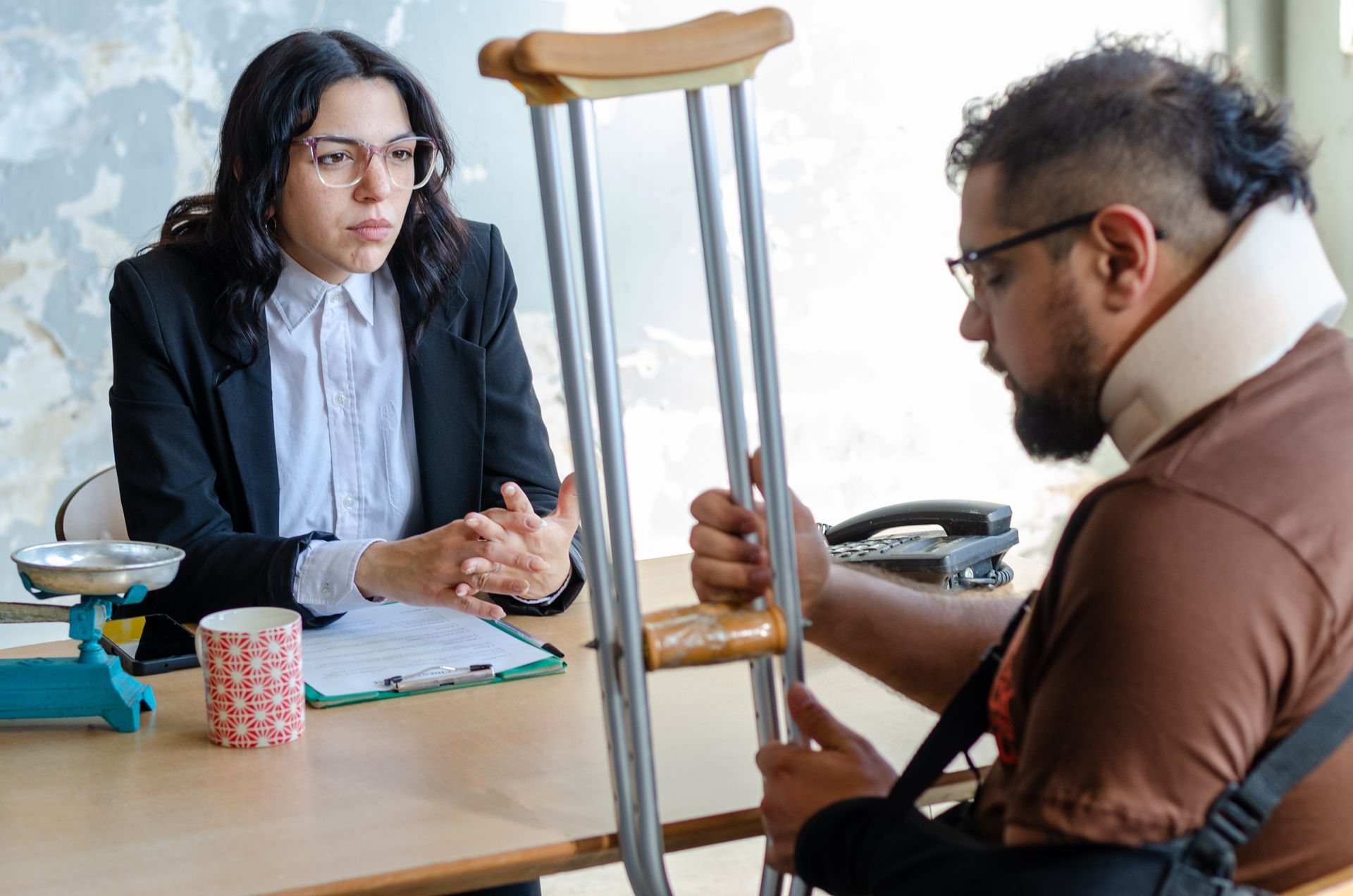 A young female lawyer assists an injured man with a legal problem. A young female lawyer assists an injured man with a legal problem.