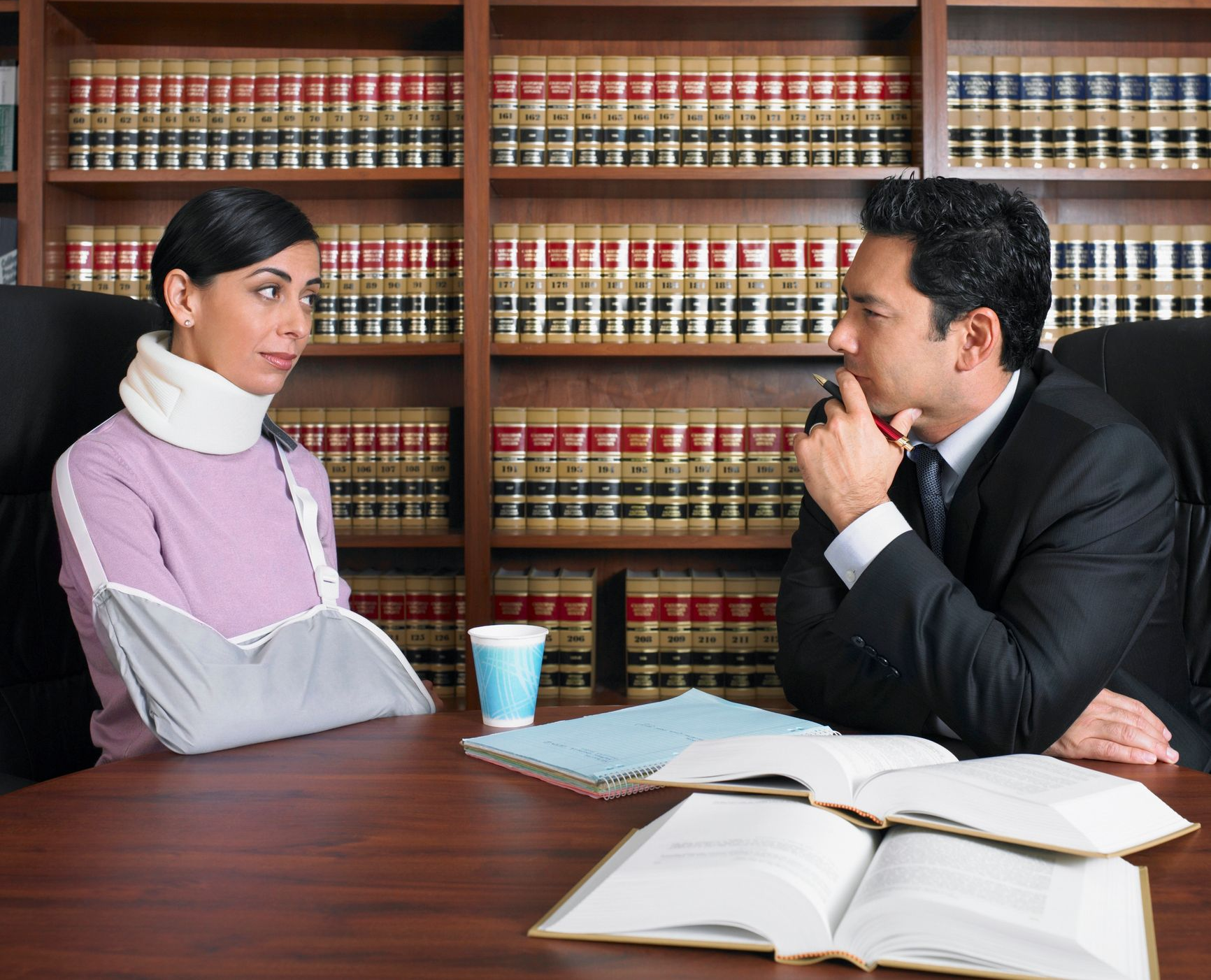 An injured woman is talking to a lawyer.