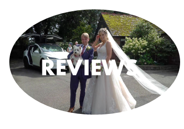 A bride and groom with their dog in front of a Tesla wedding car at The Little Fox, Thornton Hough