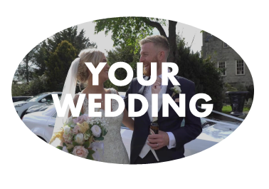 A bride and groom looking at each other in front of their wedding car