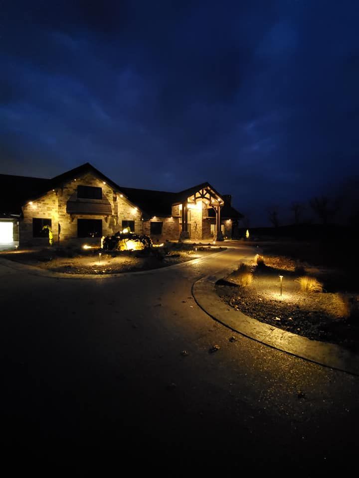 A house is lit up at night with a dark sky in the background