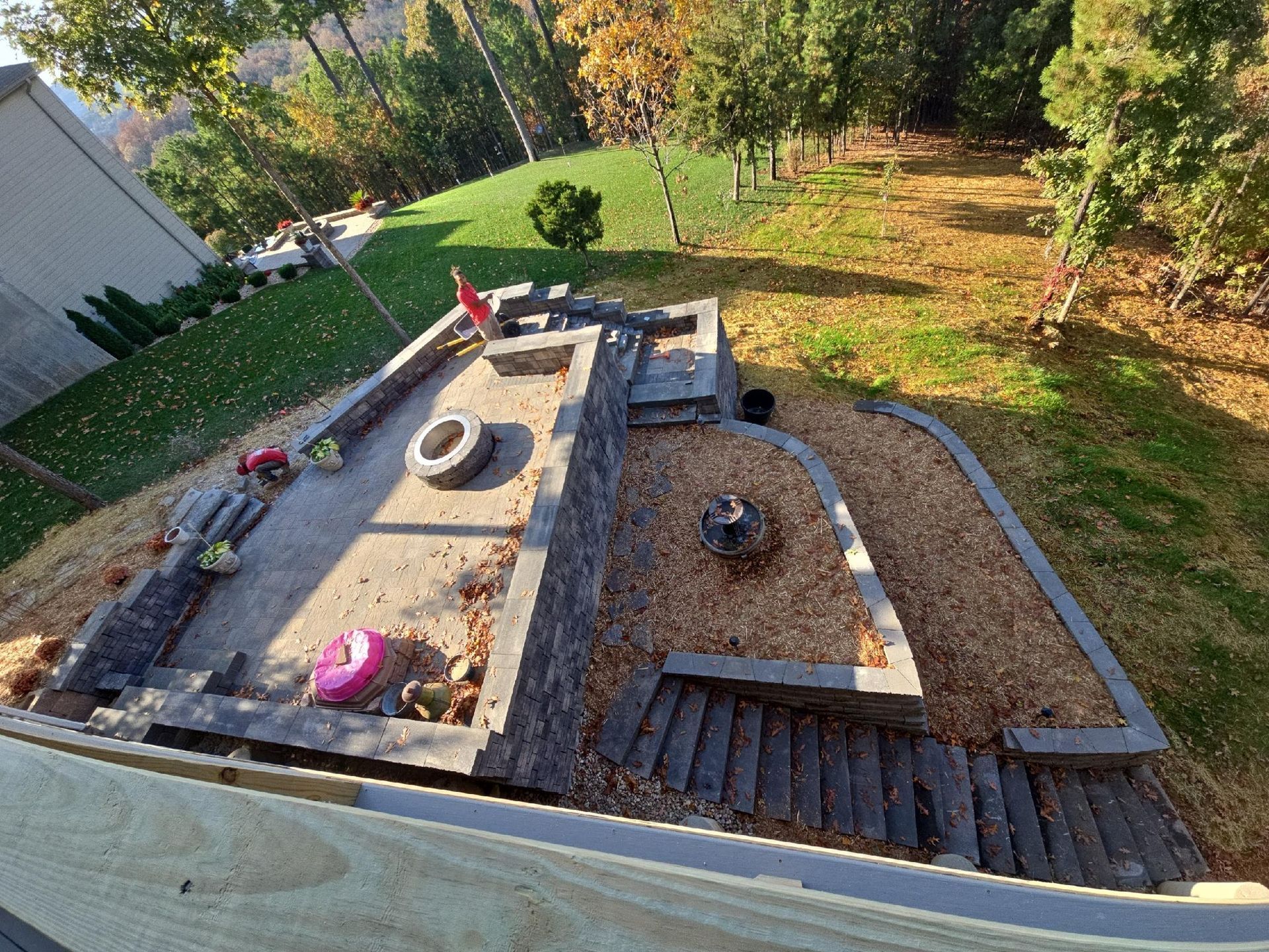 An aerial view of a rooftop garden with a tire in the middle.