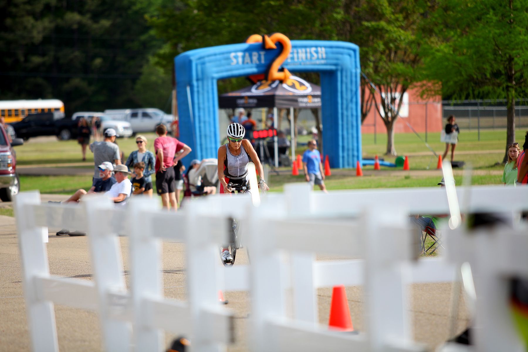A person is running through a start and finish line.