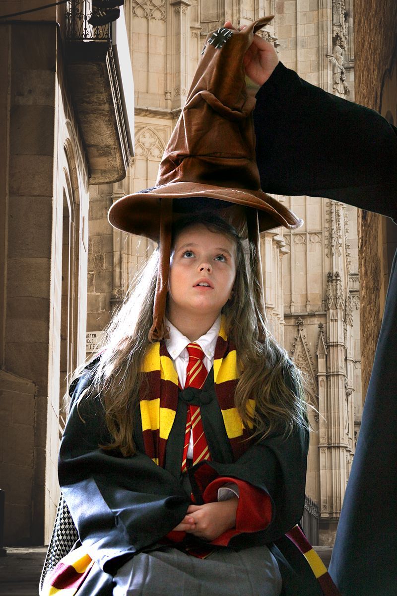 A little girl in a white dress and flower crown is running in a field.