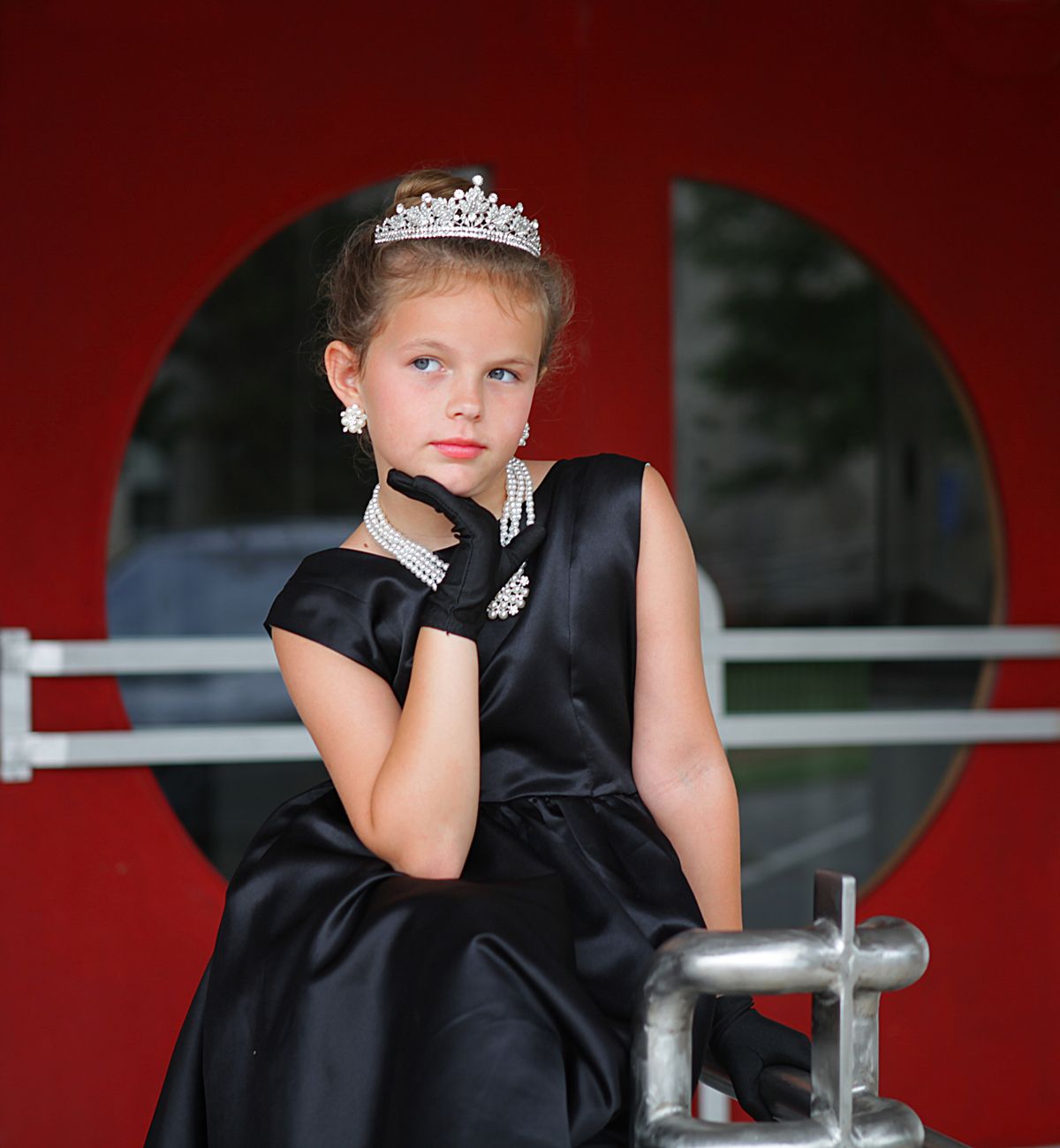A little girl wearing a black dress like Katherine Hepburn in 