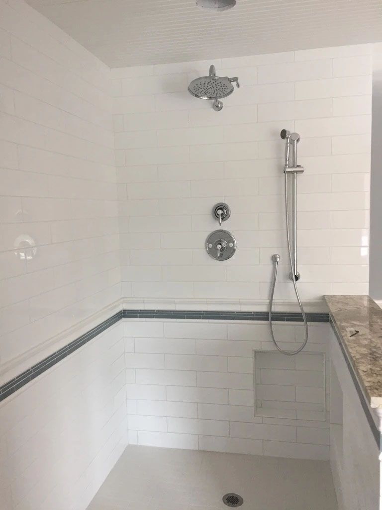 A water heater is hanging from the ceiling in a basement.