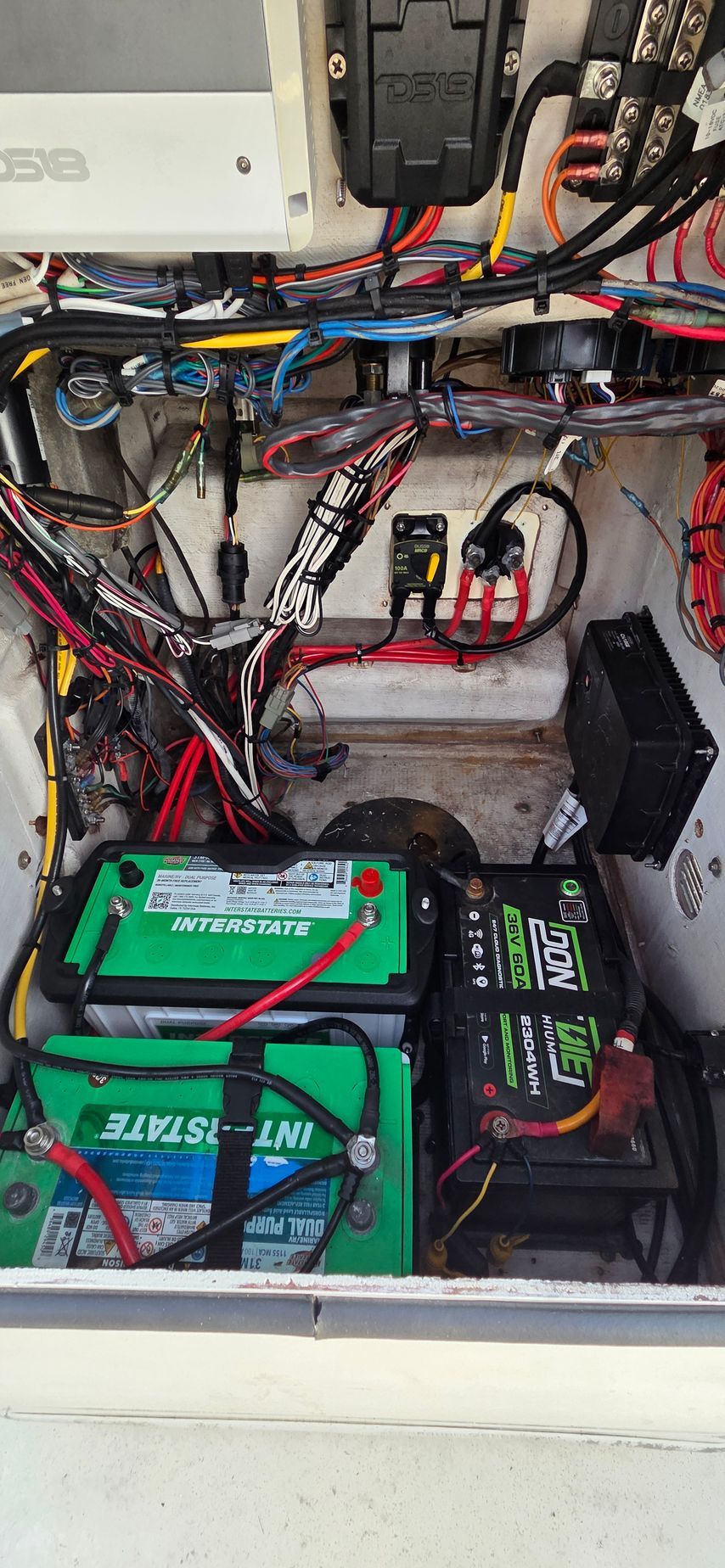 A metal drill press machine is mounted in a vise, with tools in the background.