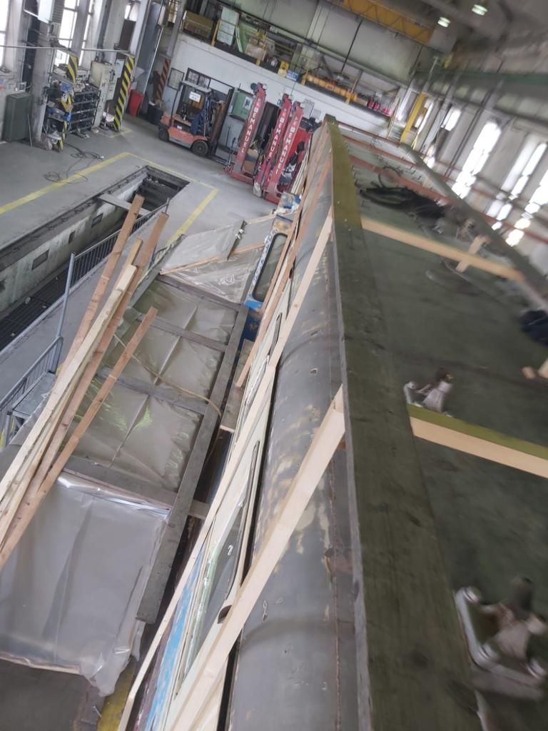 Un treno viene riparato in una fabbrica.