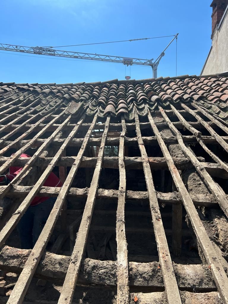 Guardando il tetto di un edificio con una gru sullo sfondo.