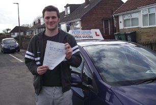 man posing with driving certificate