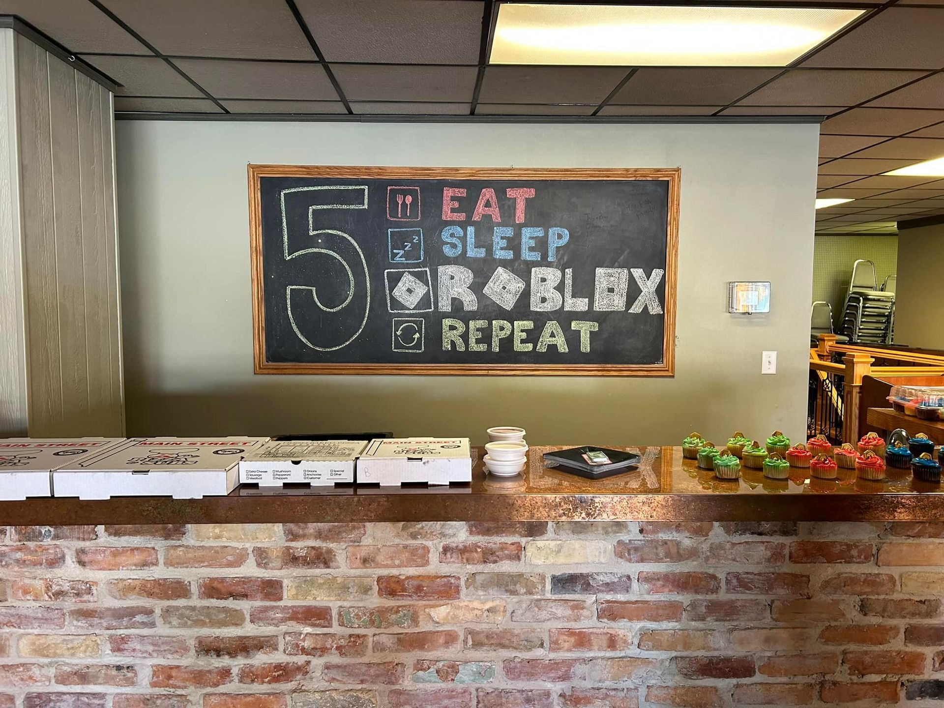 A chalkboard on a wall that says `` eat sleep roblox repeat ''