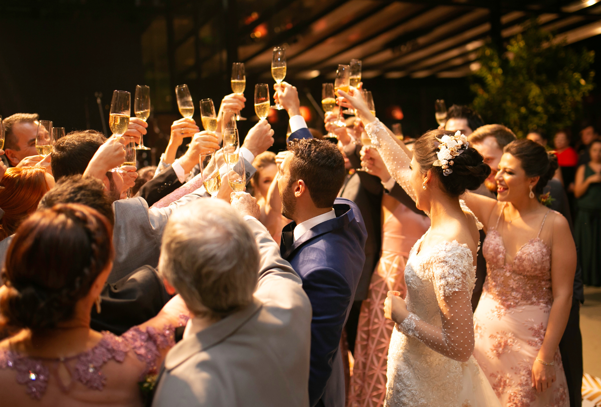 A tent with tables and chairs set up for a wedding reception.
