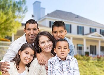 Family Portrait in Front House – Insurance Policies in Pueblo, CO
