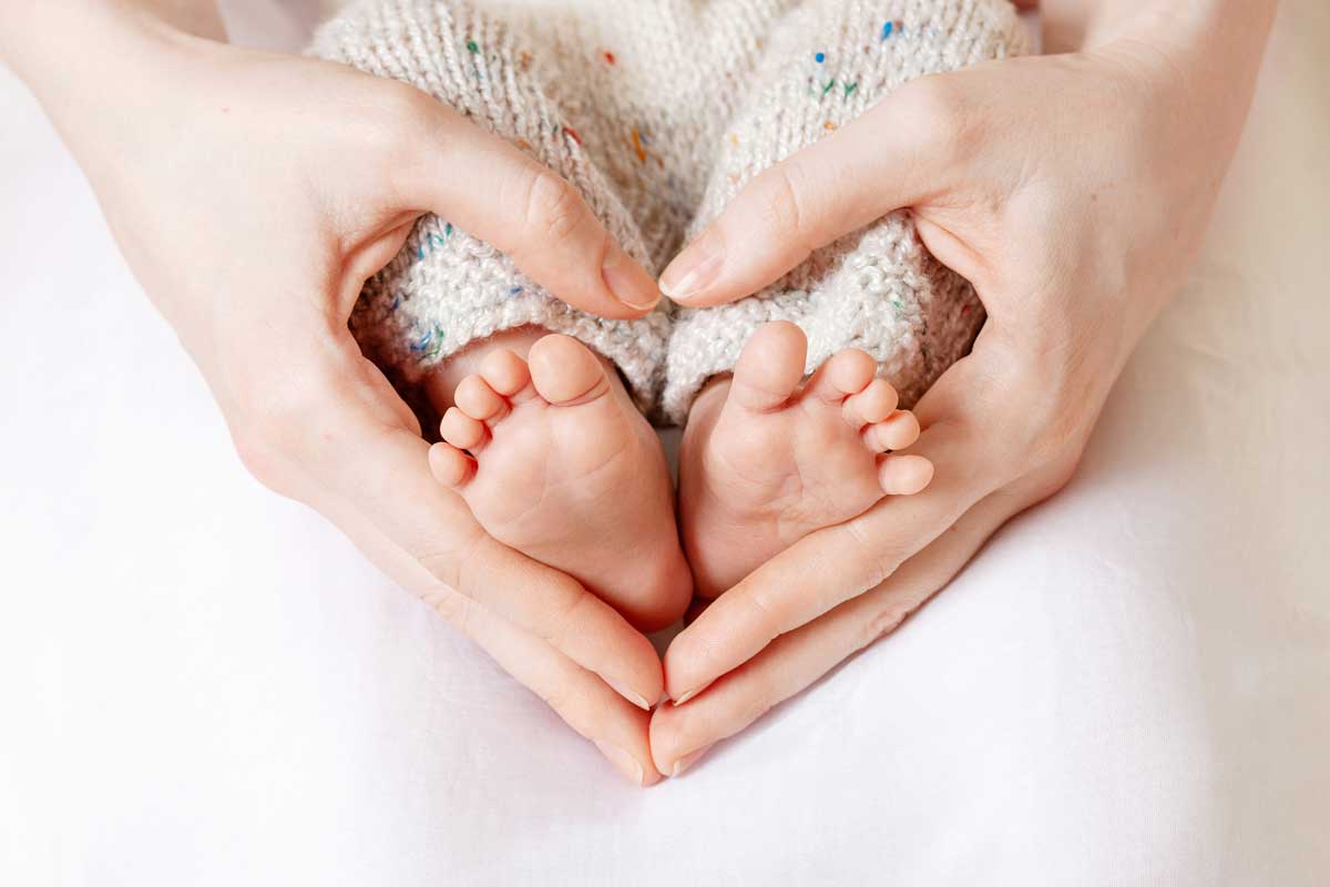 Baby Feet Inside Hands Forming A Heart Shape – Summerville, SC – Women’s Health Partners