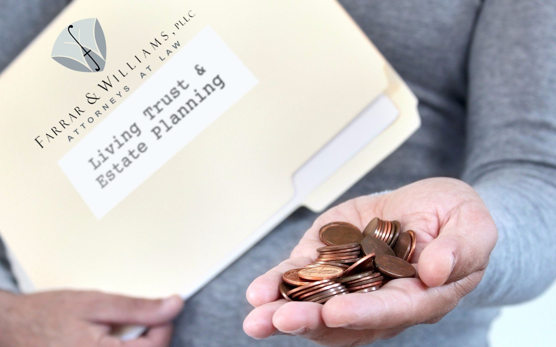 A person holding coins in front of a folder that says living trust & estate planning