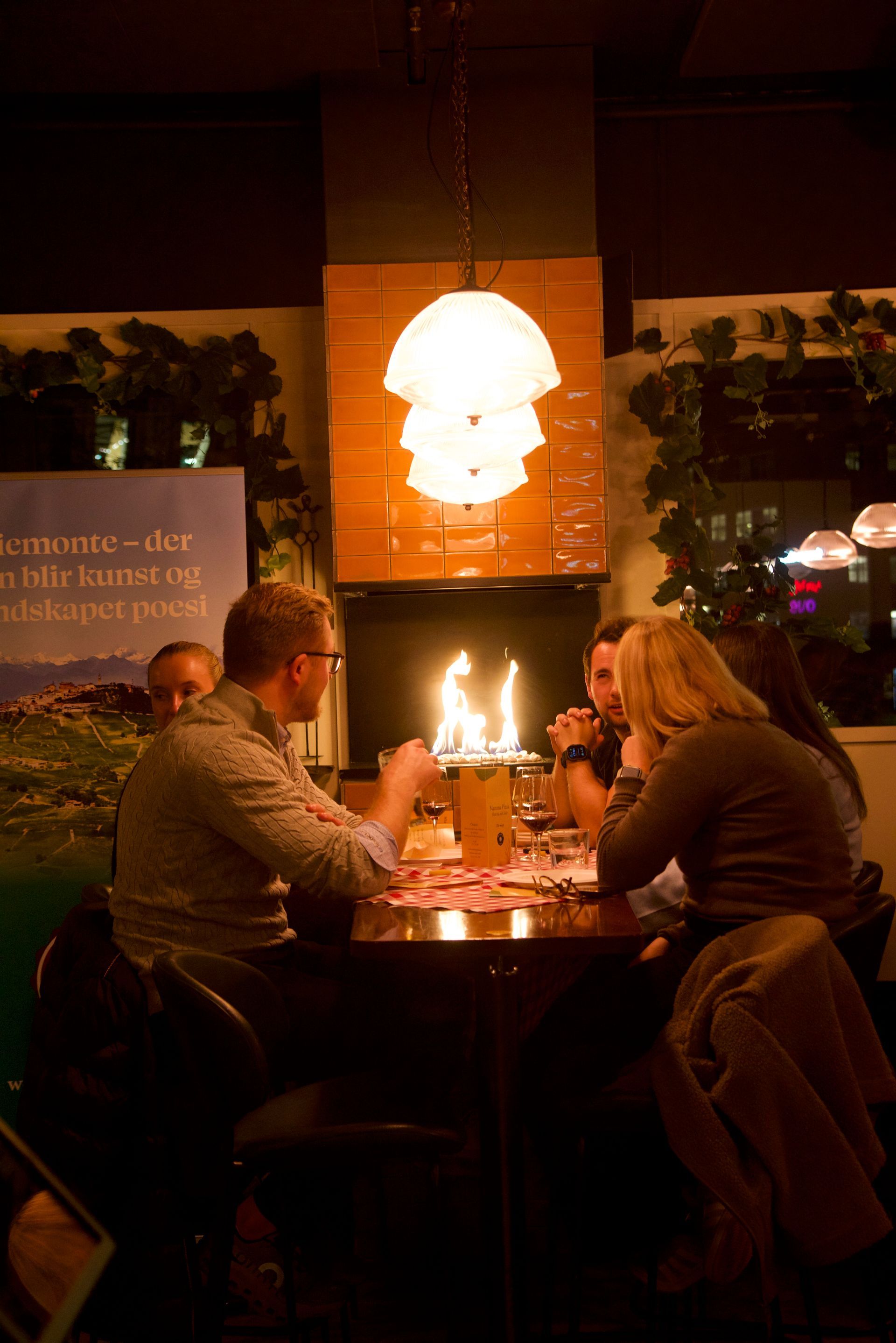 Chef smiling as he slices a large ham with a meat slicer.