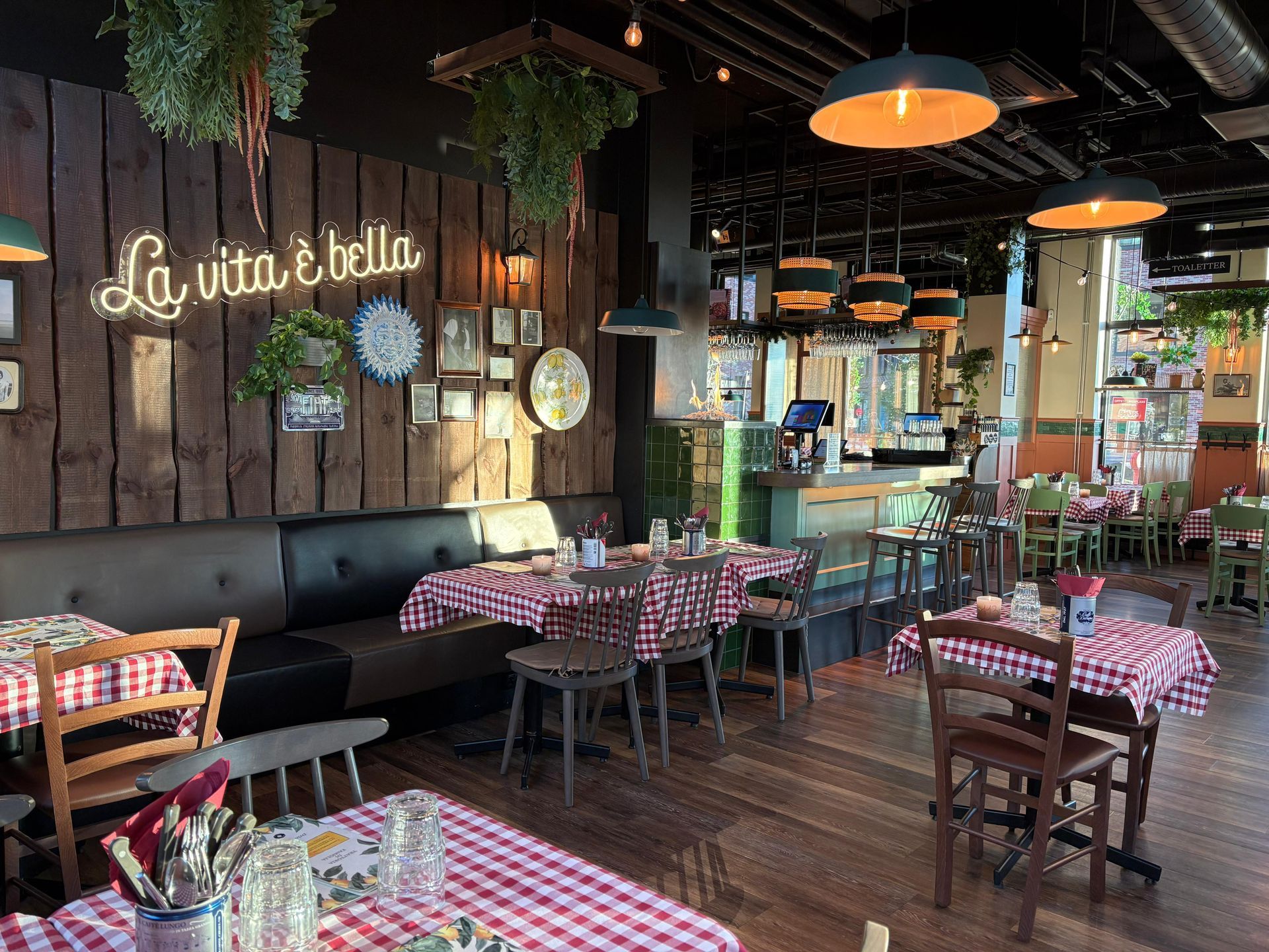 Italian restaurant interior with checkered tablecloths, wooden walls, and 