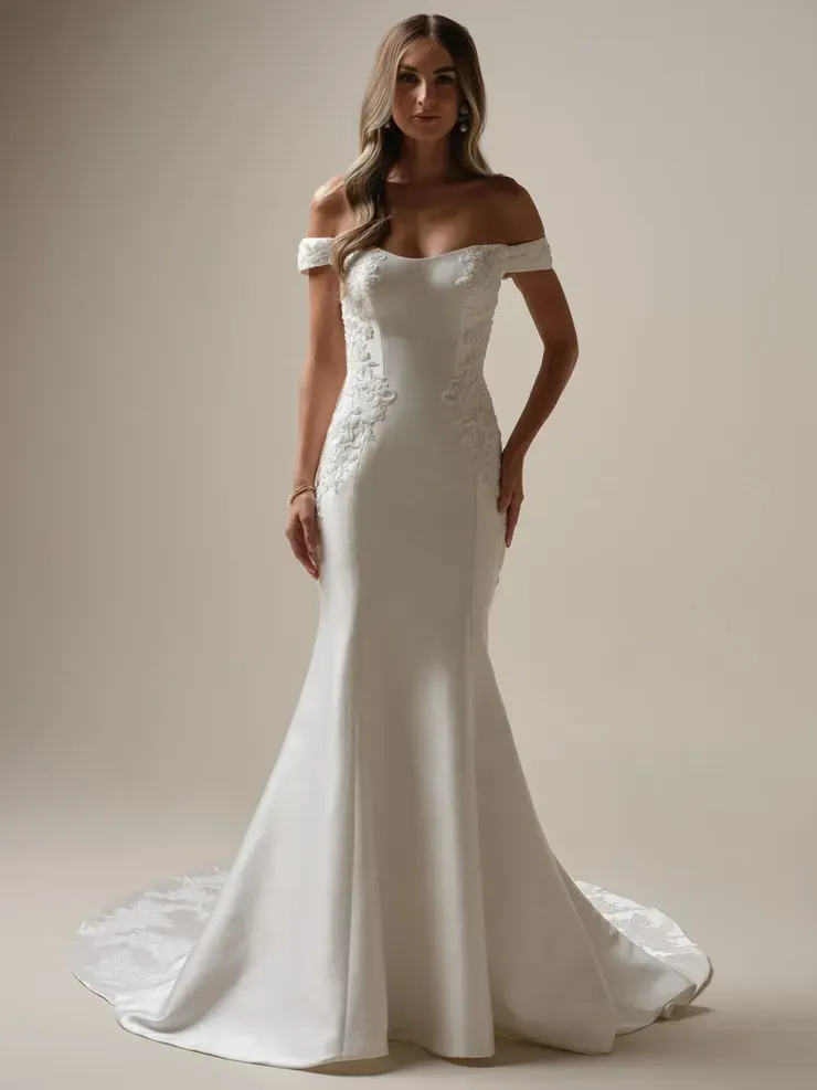 A woman is wearing a white off the shoulder wedding dress.