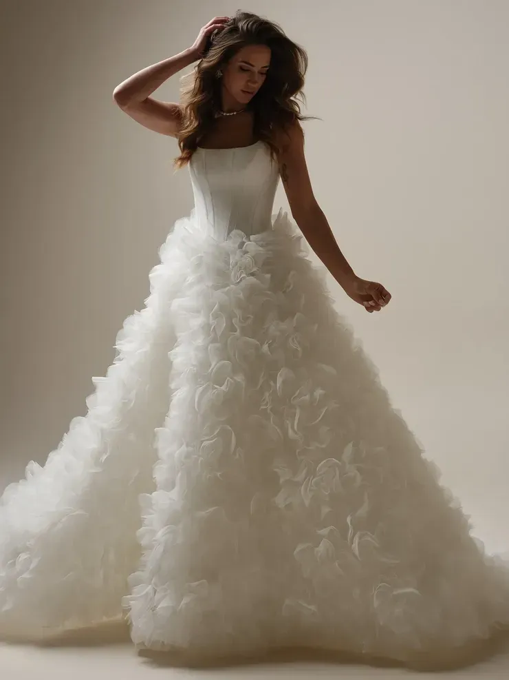 A woman is wearing a white wedding dress with ruffles on the skirt.