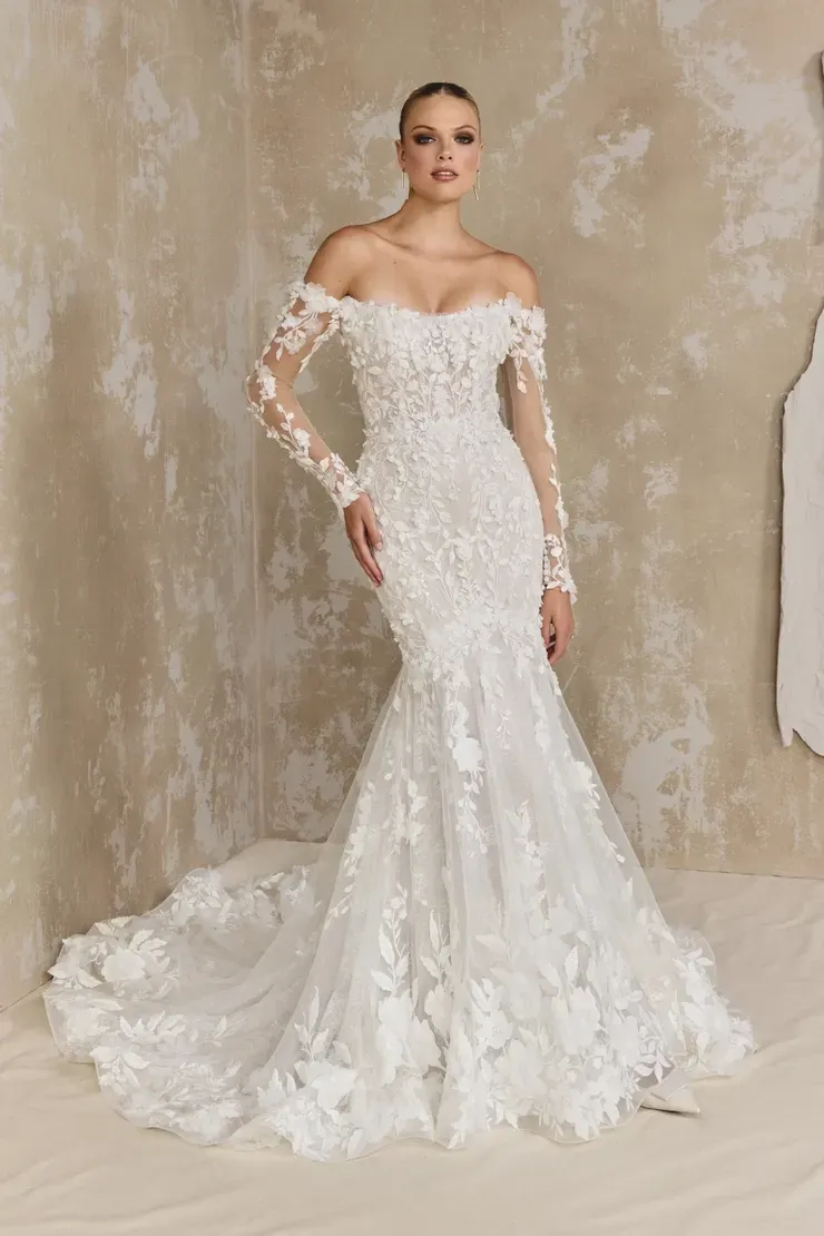 A woman is wearing a white wedding dress with long sleeves.