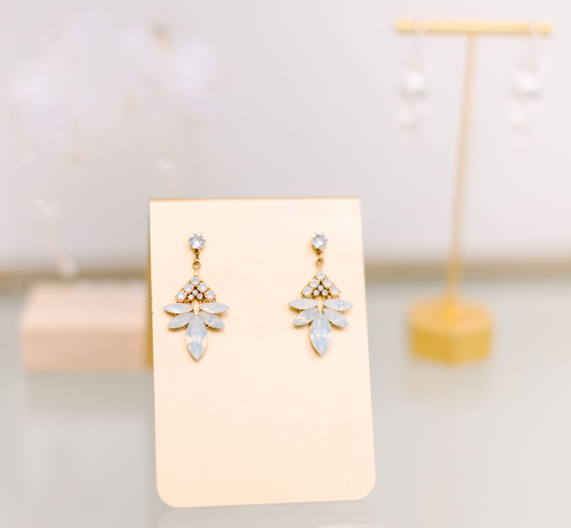 A pair of earrings are sitting on a card on a table.