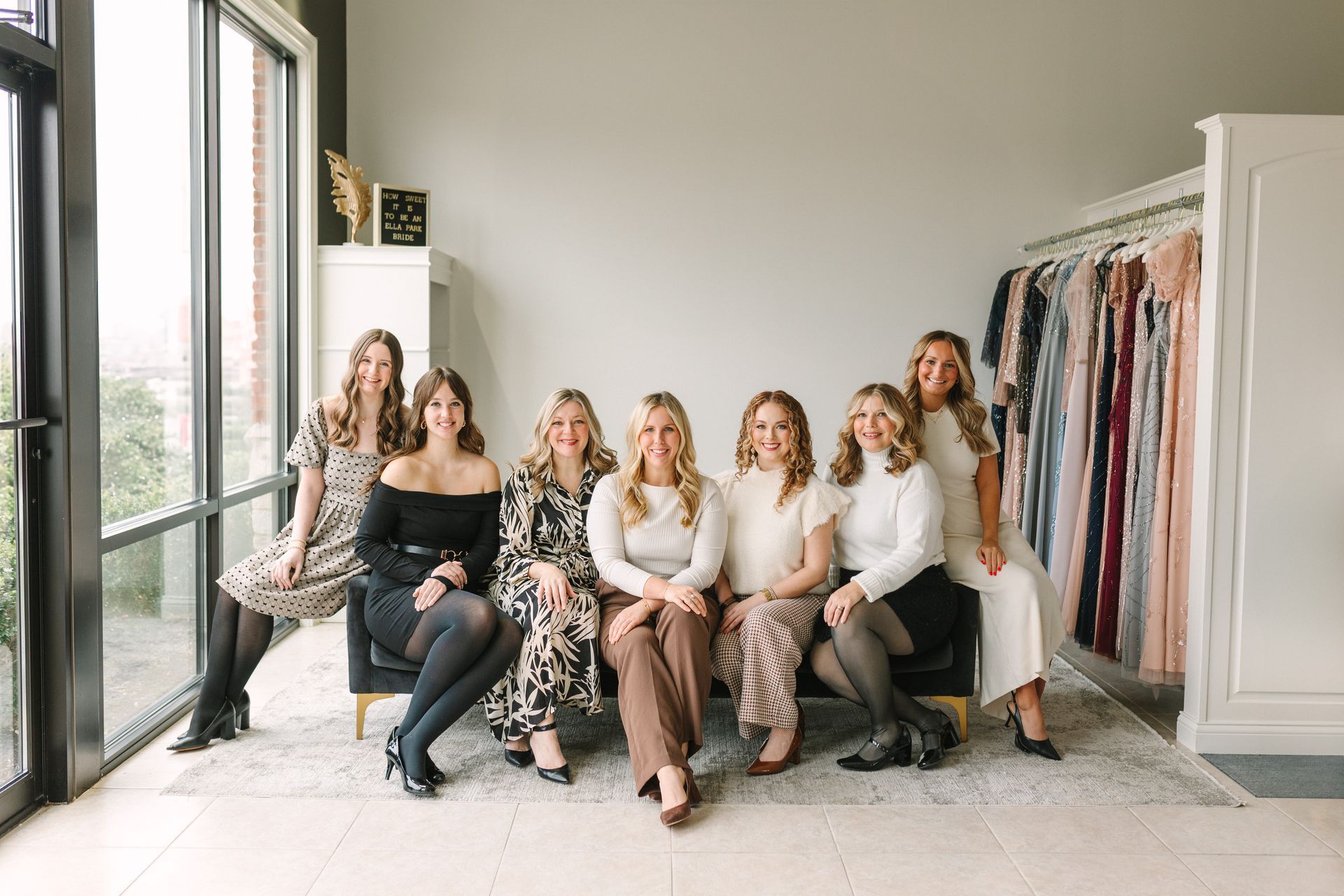 A group of women are sitting on a couch in a room.
