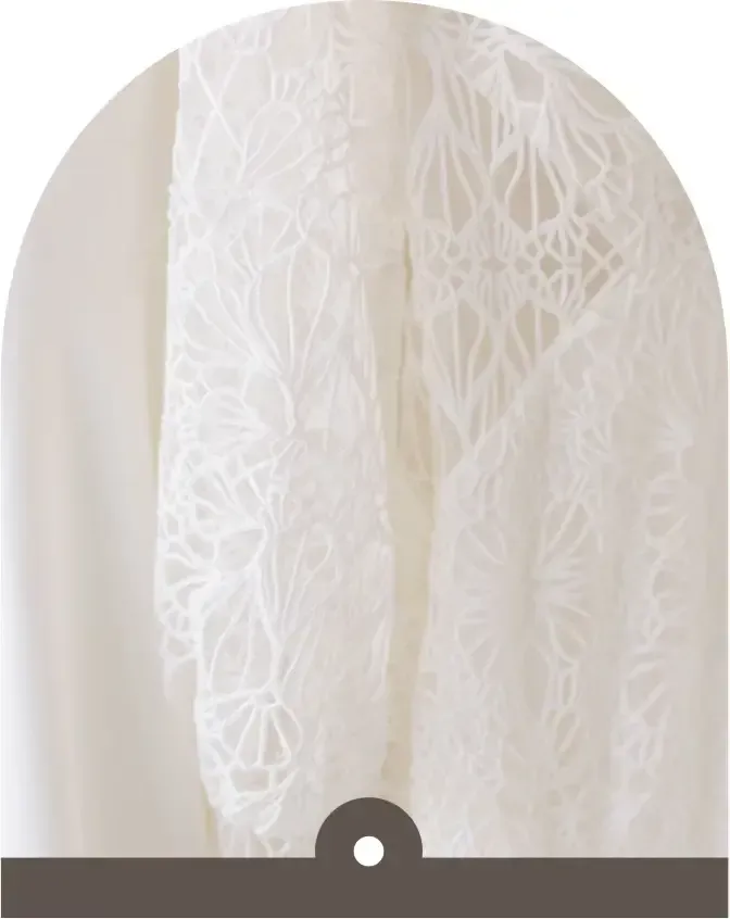 A close up of a white lace fabric with a black border.