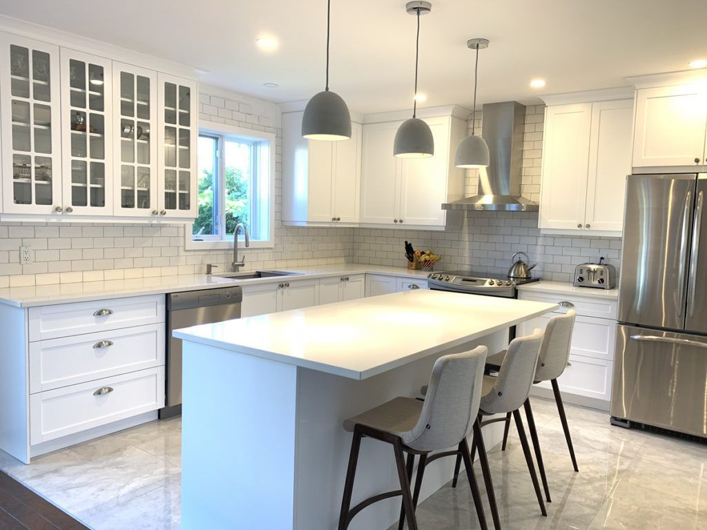 Elegent white kitchen displaying Chairs, With a stainless steel friderator and sink, Beutiful white tile backsplash by Kitchen Refacers 47 Lylewood Dr  Middle Sackville B4E3B1