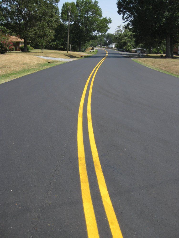 Nice asphalt road with yellow striping — South Concord, NC — Smith Brothers Asphalt Paving