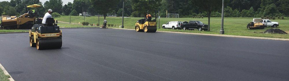 Workers on rollers on asphalt road — South Concord, NC — Smith Brothers Asphalt Paving