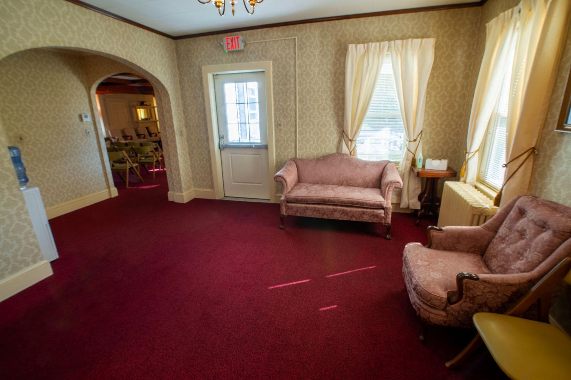 seating area that leads into the chapel with an exit door.