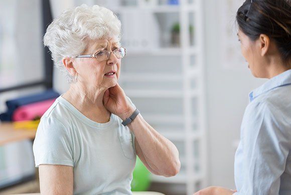 Elderly Woman Having Neck Pain — Malvern, PA — Whitelands Chiropractic Health Center