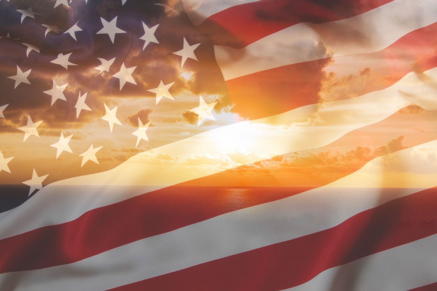 American flag waving over a warm sunset sky