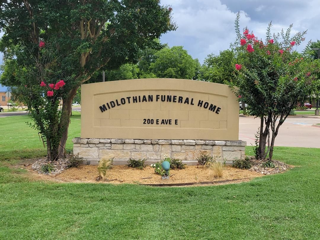 Midlothian Funeral Home sign surrounded by green grass and trees