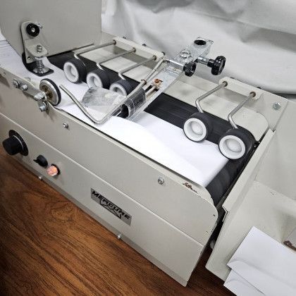 Mechanical envelope inserting machine with rollers and trays