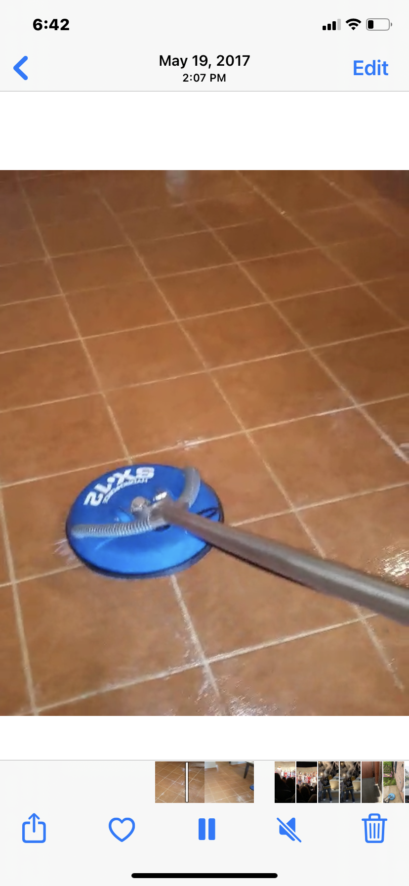 A blue floor cleaner on a brown tiled floor.
