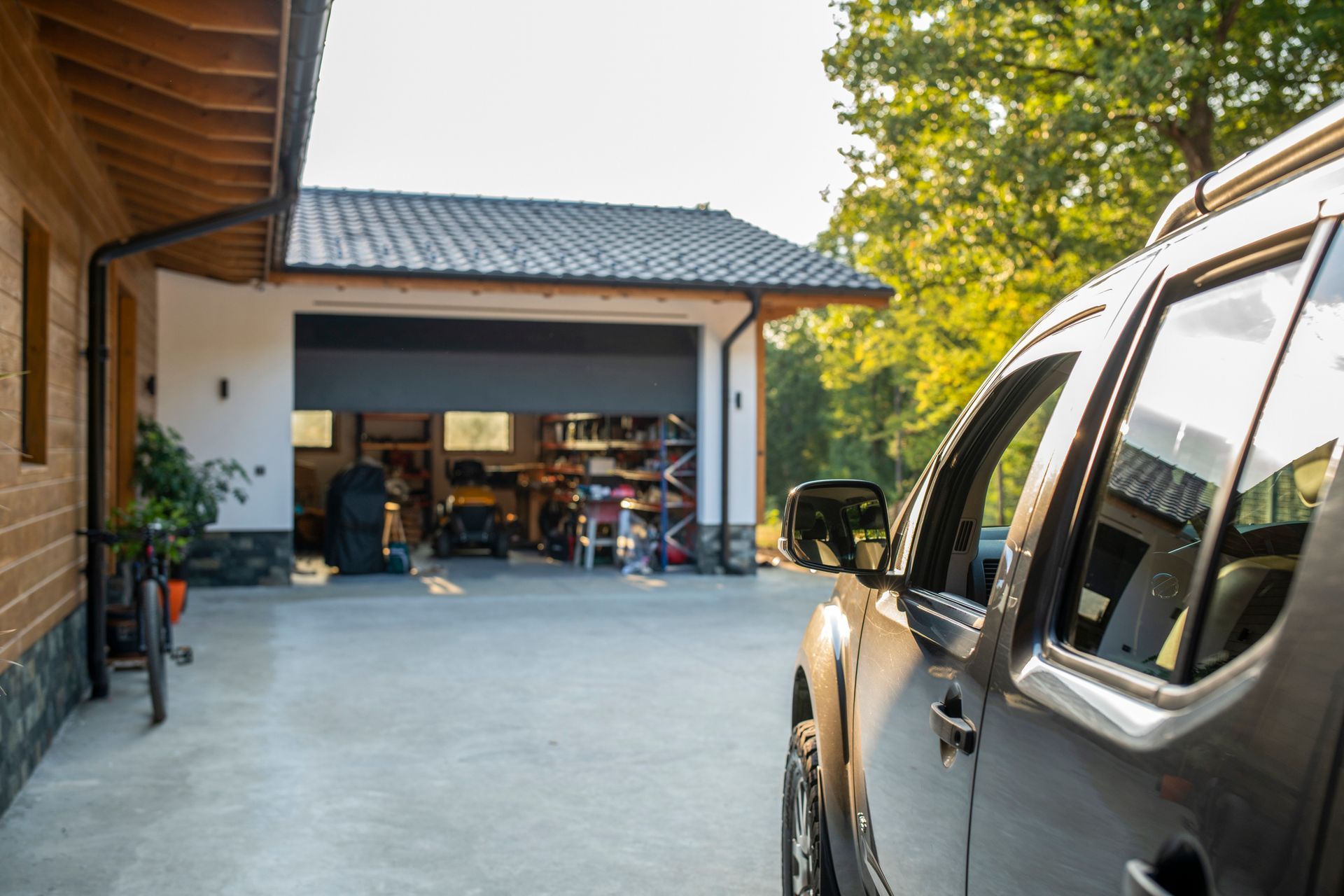 A truck is parked in front of a garage door.