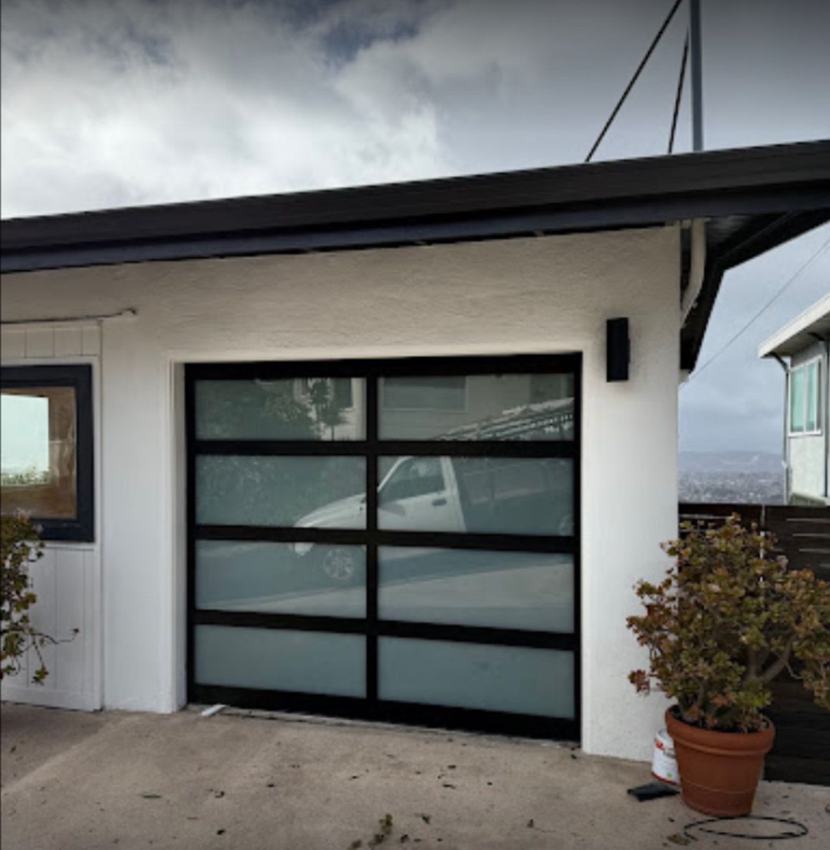 A white house with a black garage door