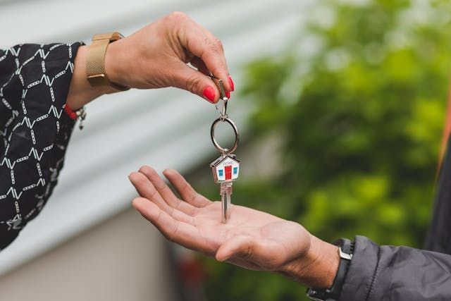 Person+passing+over+house+shaped+key