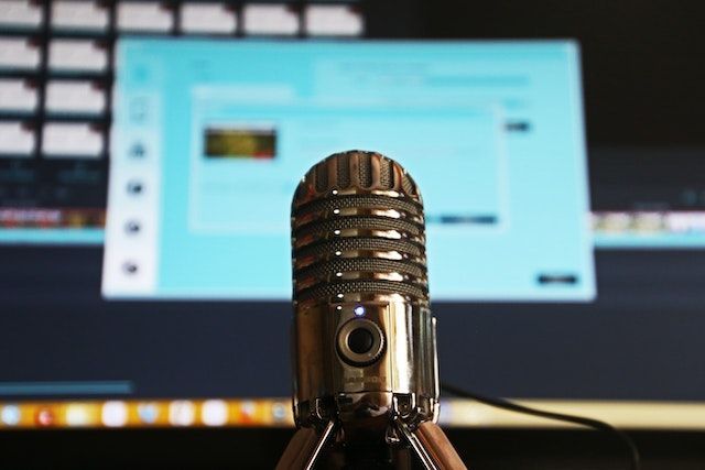 microphone in front of a monitor with audio files on it