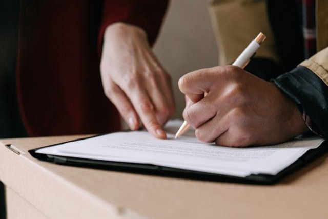 person-signing-a-lease-agreement