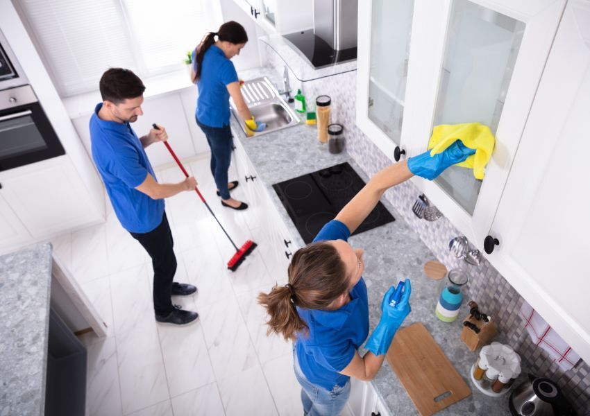 three-people-cleaning-kitchen