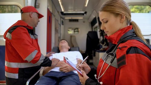 Paramedics Examining Patient — Jonesboro, GA — Caring Hearts EMS