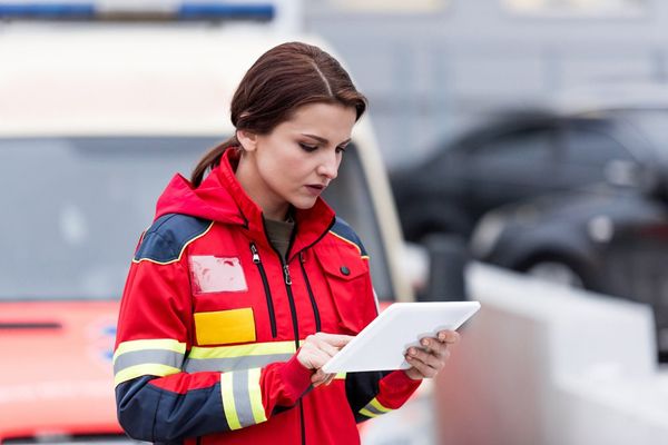Female Paramedic Using Tablet — Jonesboro, GA — Caring Hearts EMS