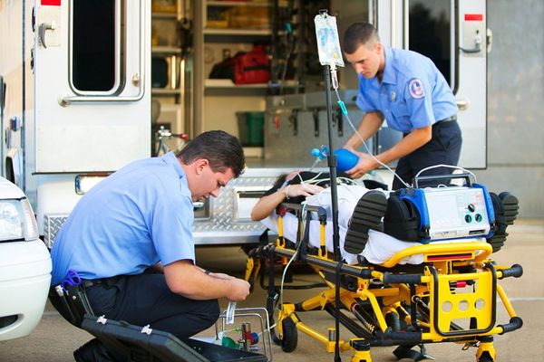 Paramedics Loading Patient Into Ambulance — Jonesboro, GA — Caring Hearts EMS