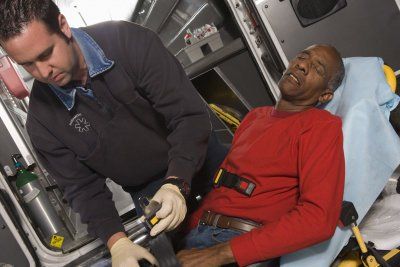 EMT Professional Taking Care Of Senior Man — Jonesboro, GA — Caring Hearts EMS