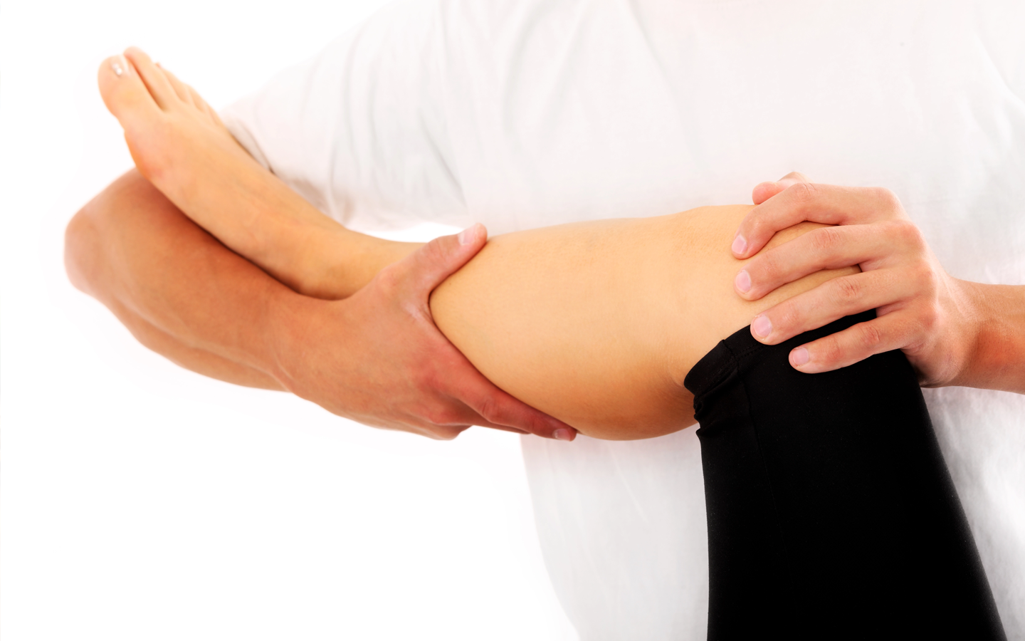 Hands supporting a bent leg during a stretch or physical therapy exercise
