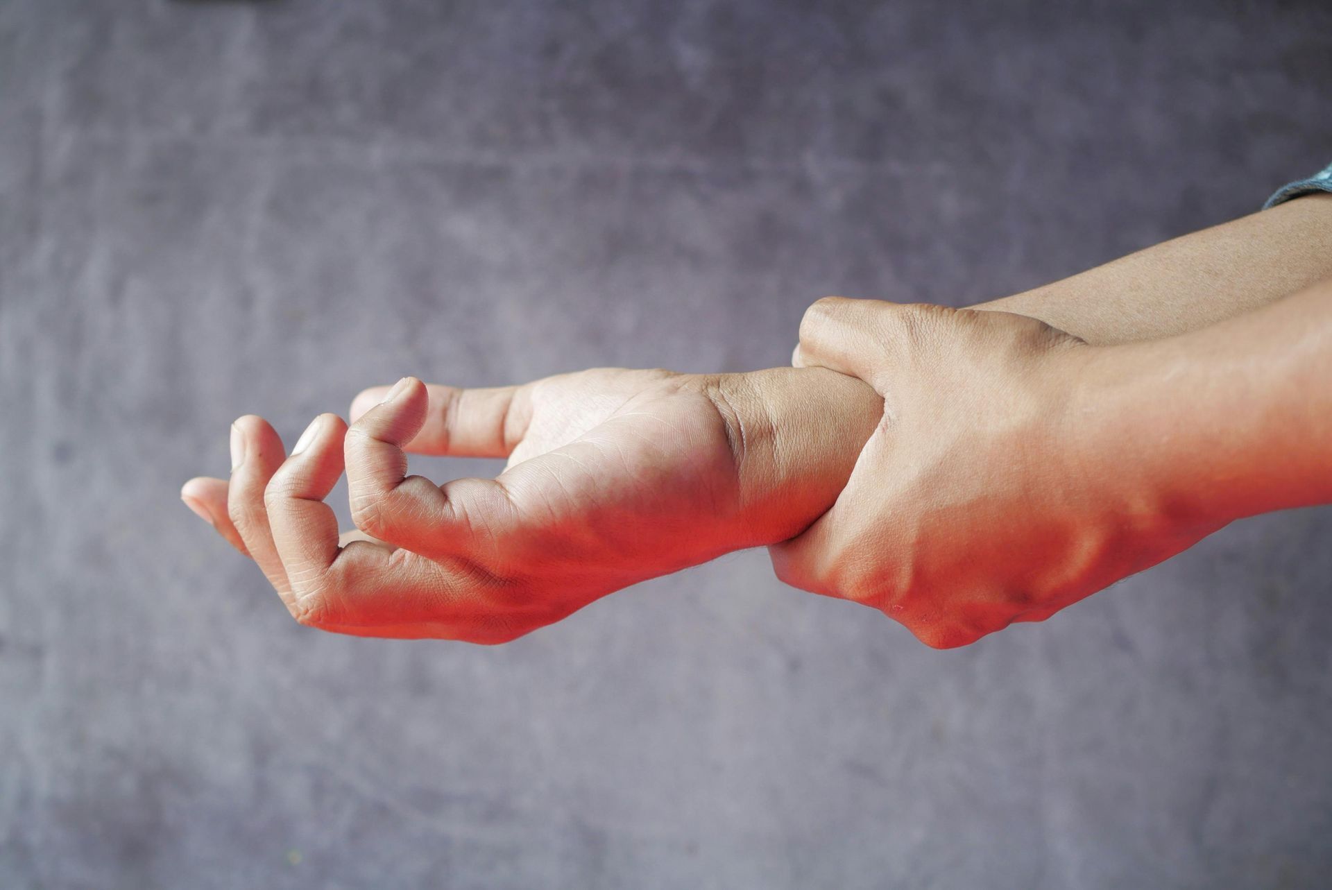 A close up of a person 's hand with a ring on it